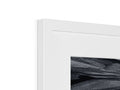 A picture of an abstract painting in black and white on a white picture frame.