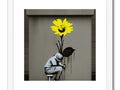 A child is standing in front of an art printed art print of yellow flowers in the
