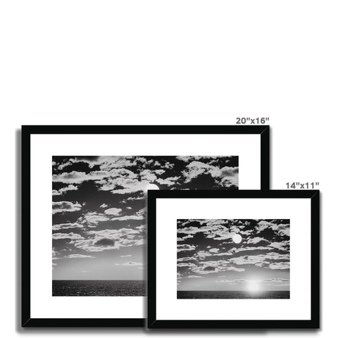 A four picture frames sitting on a black, white, and white wall.