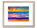 A framed photo of a sunset sitting in front of a wall with many colorful seas surrounding