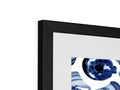 An image of a picture frame placed over a framed print on a shelf.