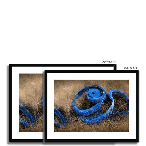 A blue ribbon framed photograph with three images hanging on a white wall.