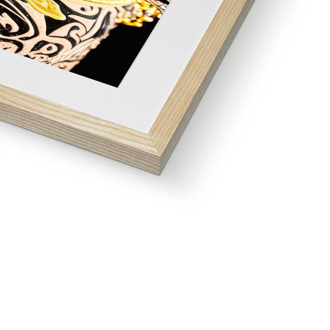 An art print with art in gold frame attached to a white page.