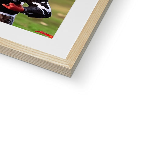 A book inside of a frame on a picture frame of a baseball player sitting on a