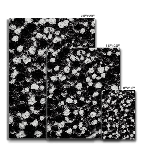A black and white photo of a white square countertop with silver tile with flowers.