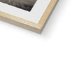 A picture frame with two photographs showing a book on a white background and one on a