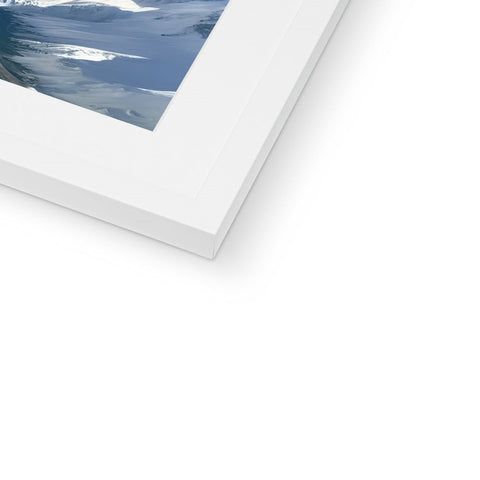 A white photo is on a white background on a wall of a picture frame.