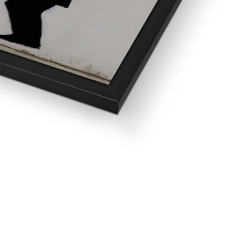 a white framed picture of an abstract photograph sitting on top of a metal frame.