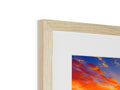 A picture on a wooden frame with a sun setting is on top of it.