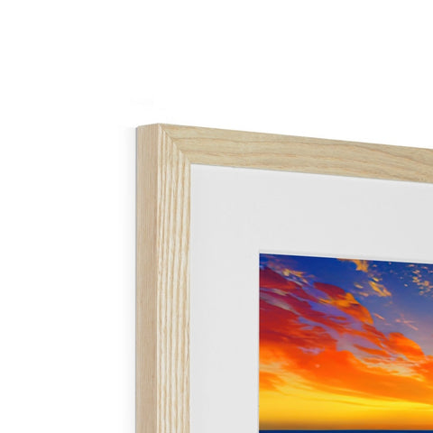 A picture on a wooden frame with a sun setting is on top of it.