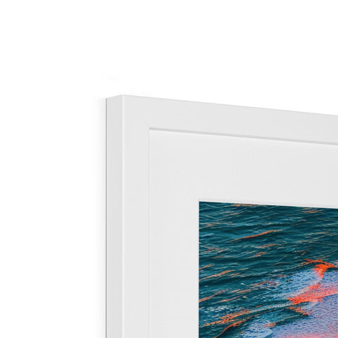 A photo is stuck on top of a framed frame in a picture frame with art printed