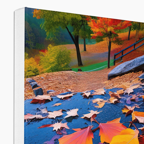 A green blanket covered in autumn leaves is on a hardcover photo.