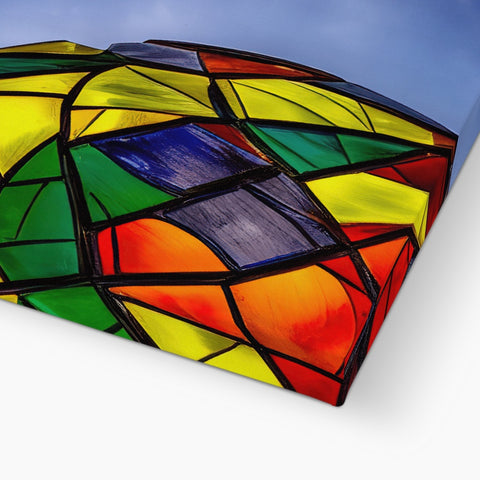 The rainbow kite has a curved ribbon design.