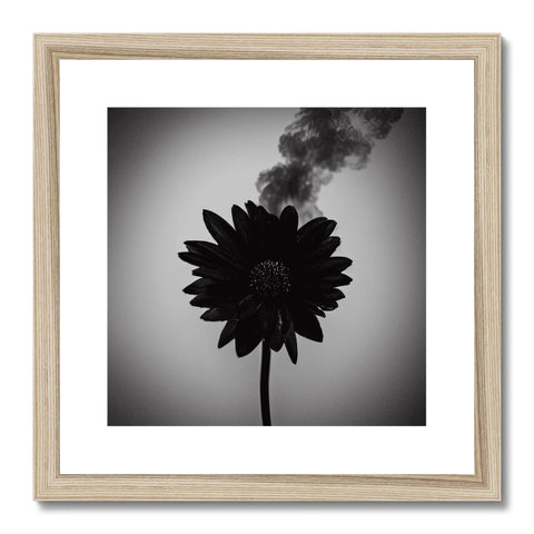 Wooden picture is framing a stack of smoke stacks with a smoke print inside of a