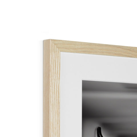 a picture frame held in a wooden frame with light grey and white in it