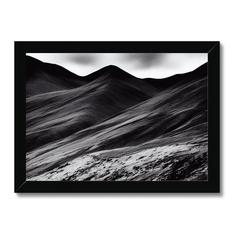 a very flat desolate black and white flat field of mountains and river