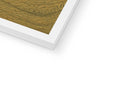 White panel of wood inside a photo frame, sitting on a table with green paper