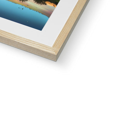 A wooden frame is sitting on top of a white picture frame in wood.
