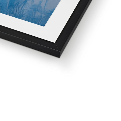 A picture frame with black and white prints attached in a white background.