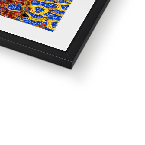 A picture is in a blue tiled frame with silver and gold colored artwork.