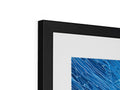 A blue picture frame in a frame with two images in it.