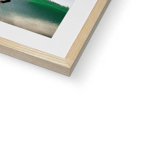 A picture frame with a shortboard sitting next to the top of a picture frame of