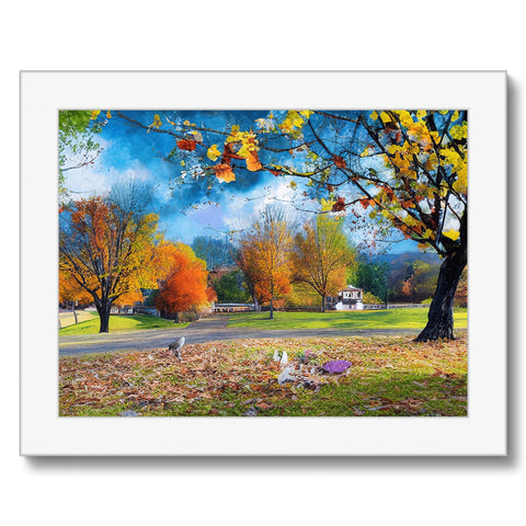 A colorful photo print of a very lush green country setting surrounded in different colors by trees
