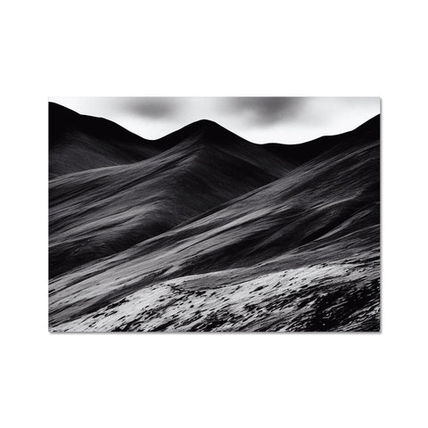 Black and white photos of the landscape with red mountains and snow covered mountainsides.