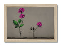 A wooden art print with flowers and spray paint against the walls.