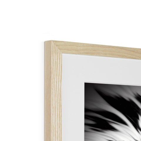 a white photo with black art sitting top of a picture frame