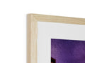 A picture frame holding a close up of a picture in a wood framed frame