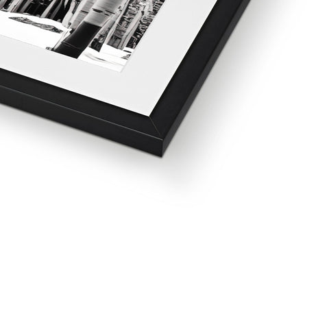 A photo of a black and white picture frame holding a box filled with different types of