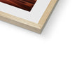 a piece of wood is on top of a picture frame beside a large picture