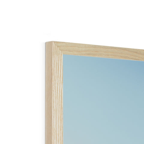 A wooden picture frame with a white mirror on top of a window sill.