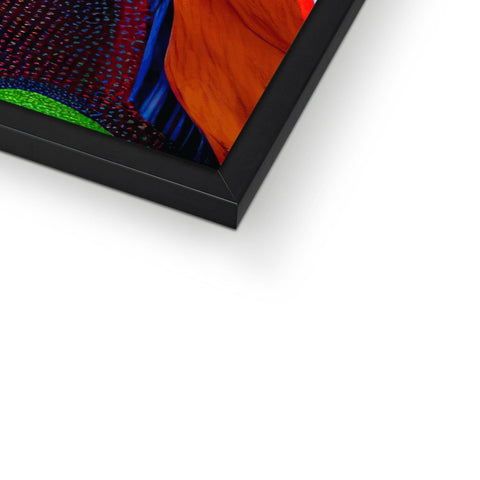 A colorful kite hanging in a picture frame next to a computer computer on a metal