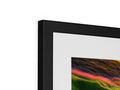 A colorful photograph on a picture frame next to a silver computer file.