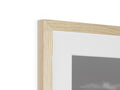 A photo in a white frame with some sort of wood in the middle of it.
