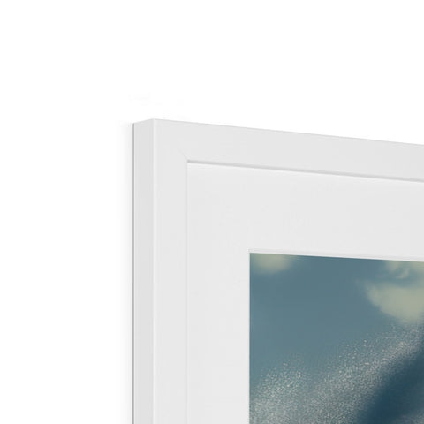 A picture frame hanging over a window under a frosted picture of a glass.