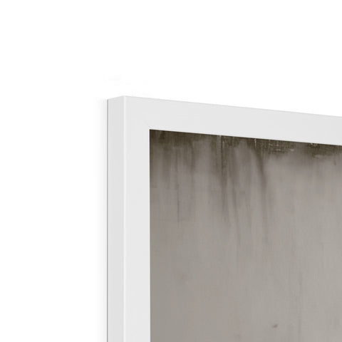 This photo is of a white wall next to a window of a house surrounded by cement