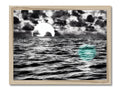A wooden framed print of some seas surrounding a beach with a ship floating in the water
