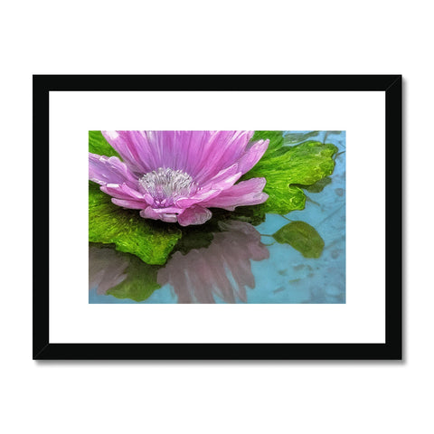A picture of a purple flower sitting on a wood frame with an art print on it