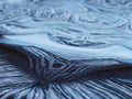 A close up of a table topped with a black velvet scarf surrounded with blue cloth.
