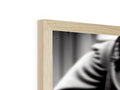 A black and white photo taken from a wooden frame is on a photo frame.