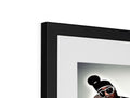 A black framed photo hanging on a wall with a little wooden frame on top