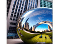 A mirrored wall of the city of Chicago holding a mouse pad and a mirror.
