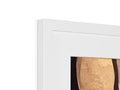 A white mirror with gold framed art sitting on top of the shelf topped with a white