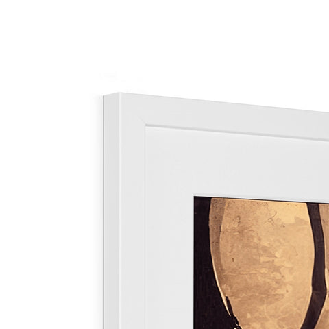 A white mirror with gold framed art sitting on top of the shelf topped with a white