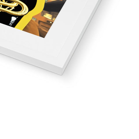 Gold foil covers a photo of the trombone on a black frame.