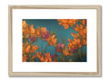 A framed art print of flowers with a bird sitting outside on a wall.
