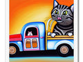 An art print in a car window on an antique car next to a striped cat.